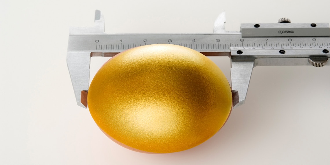 A golden egg being measured.